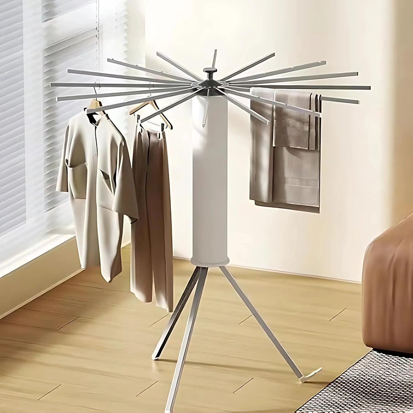 360° rotating stainless steel clothes drying rack with foldable arms with clothes in that