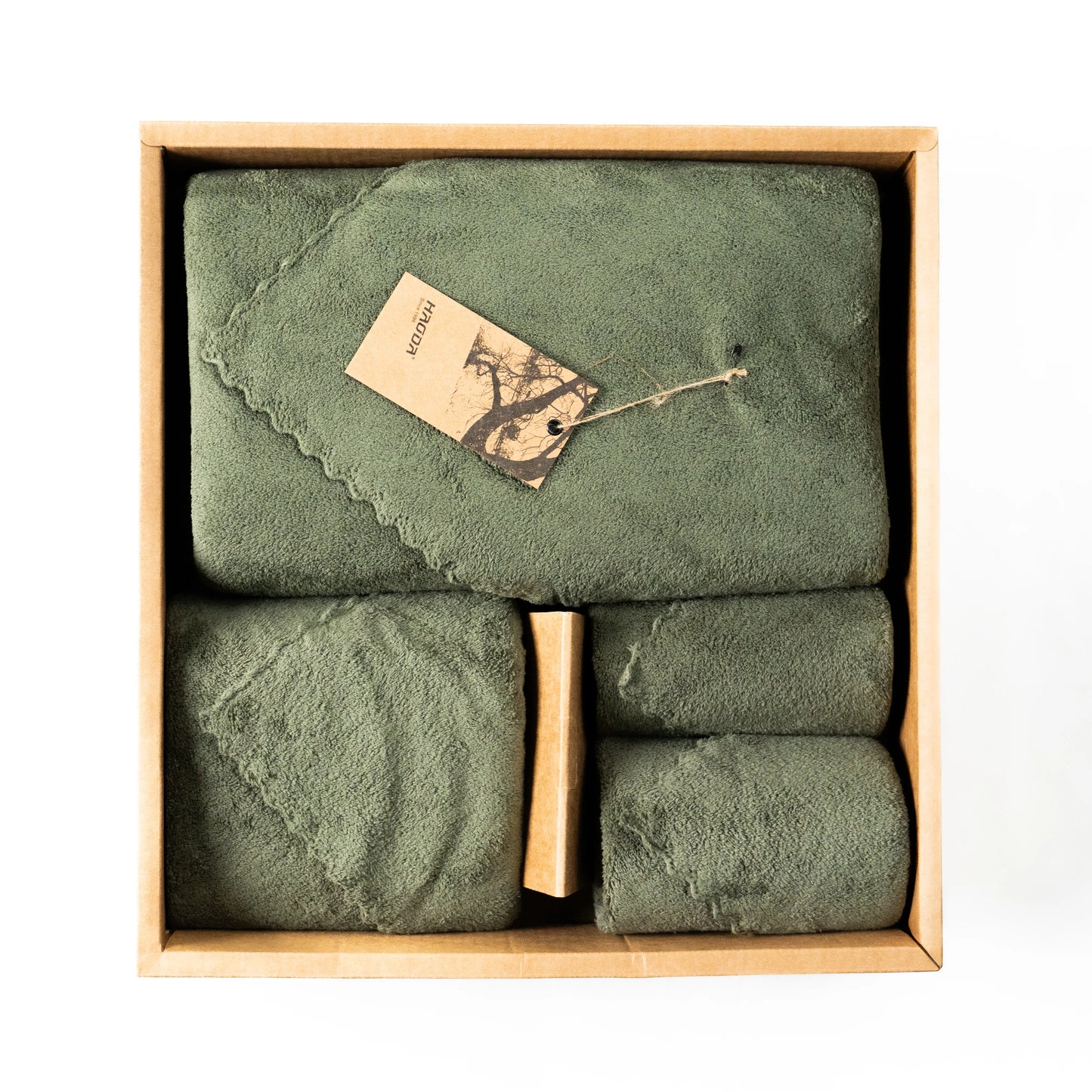 Neatly folded olive green towels from the Soft Craze set in four practical sizes