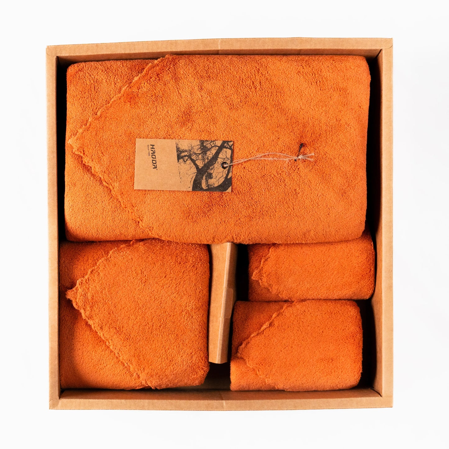 Soft Craze 4-Piece Size-Varied Towel Set in vibrant orange displayed in stacked arrangement