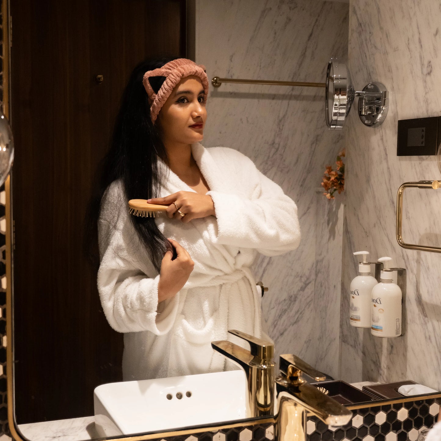 Woman using combo set in a bathroom mirror scene.