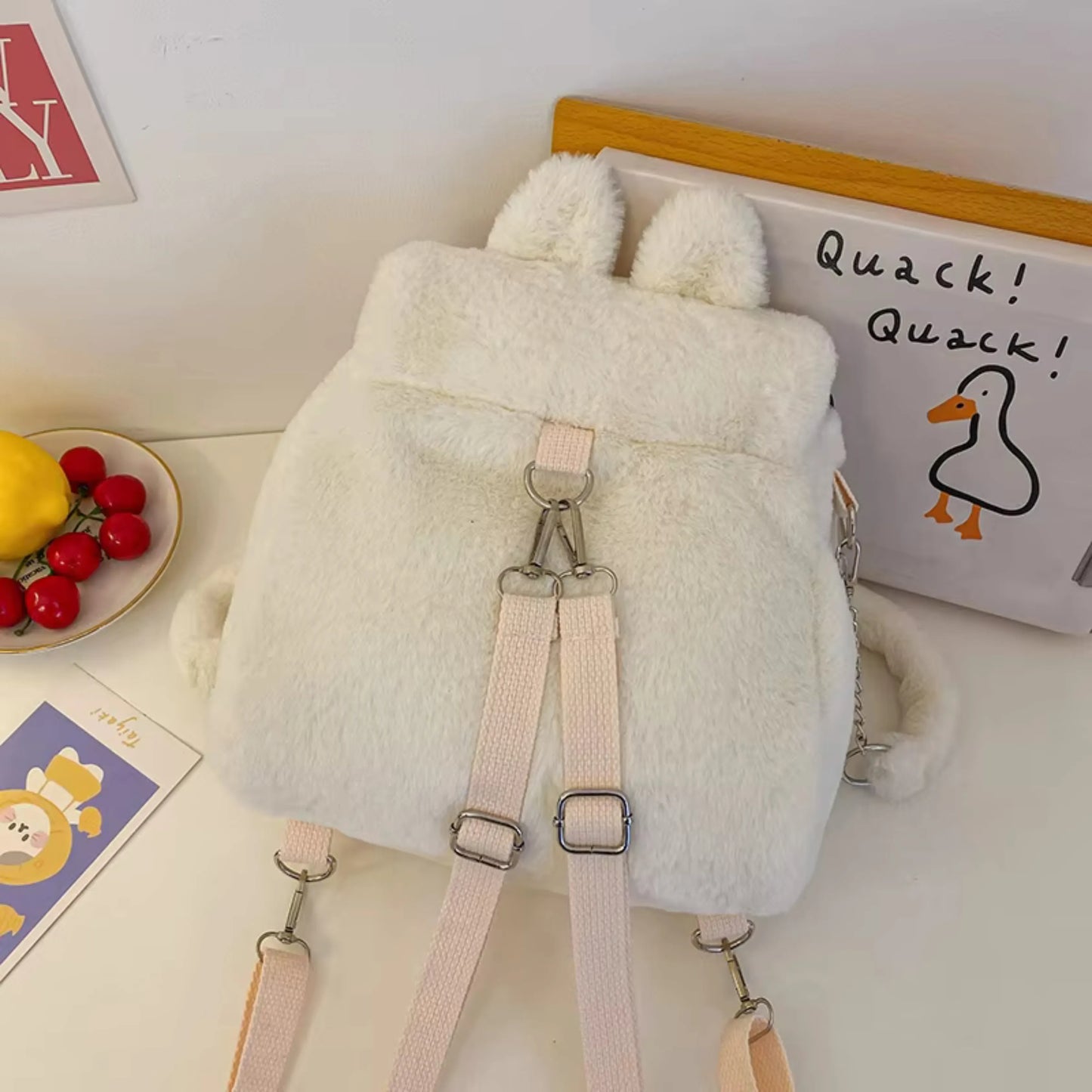 Fluffy white convertible backpack with strap