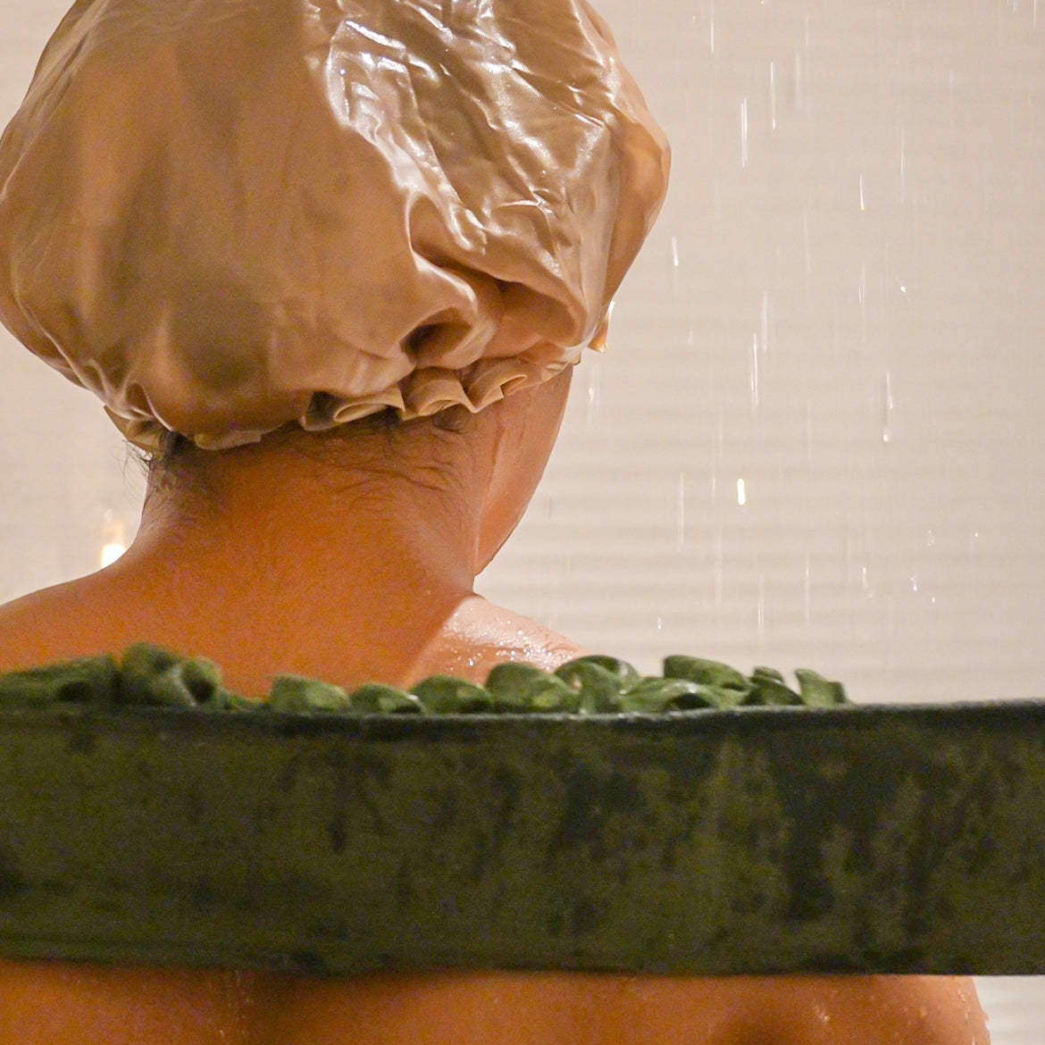 Woman using the deep green glow loop on her back.