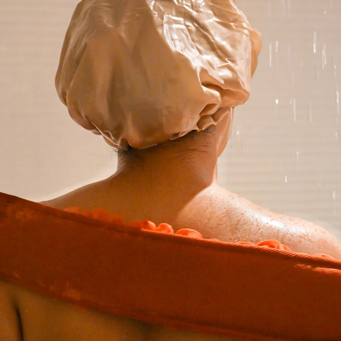 Woman using the orange glow loop on her back.
