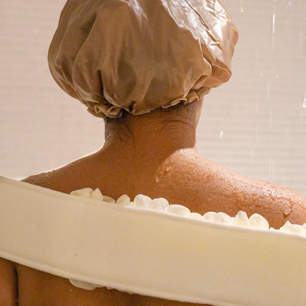 Woman using the white glow loop on her back.