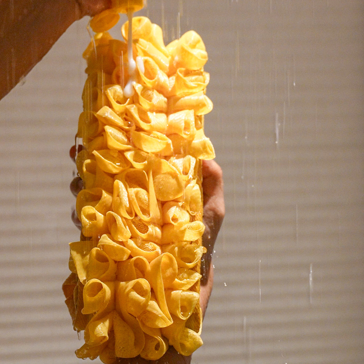 Glow loop held by a person with water falling on it in the shower