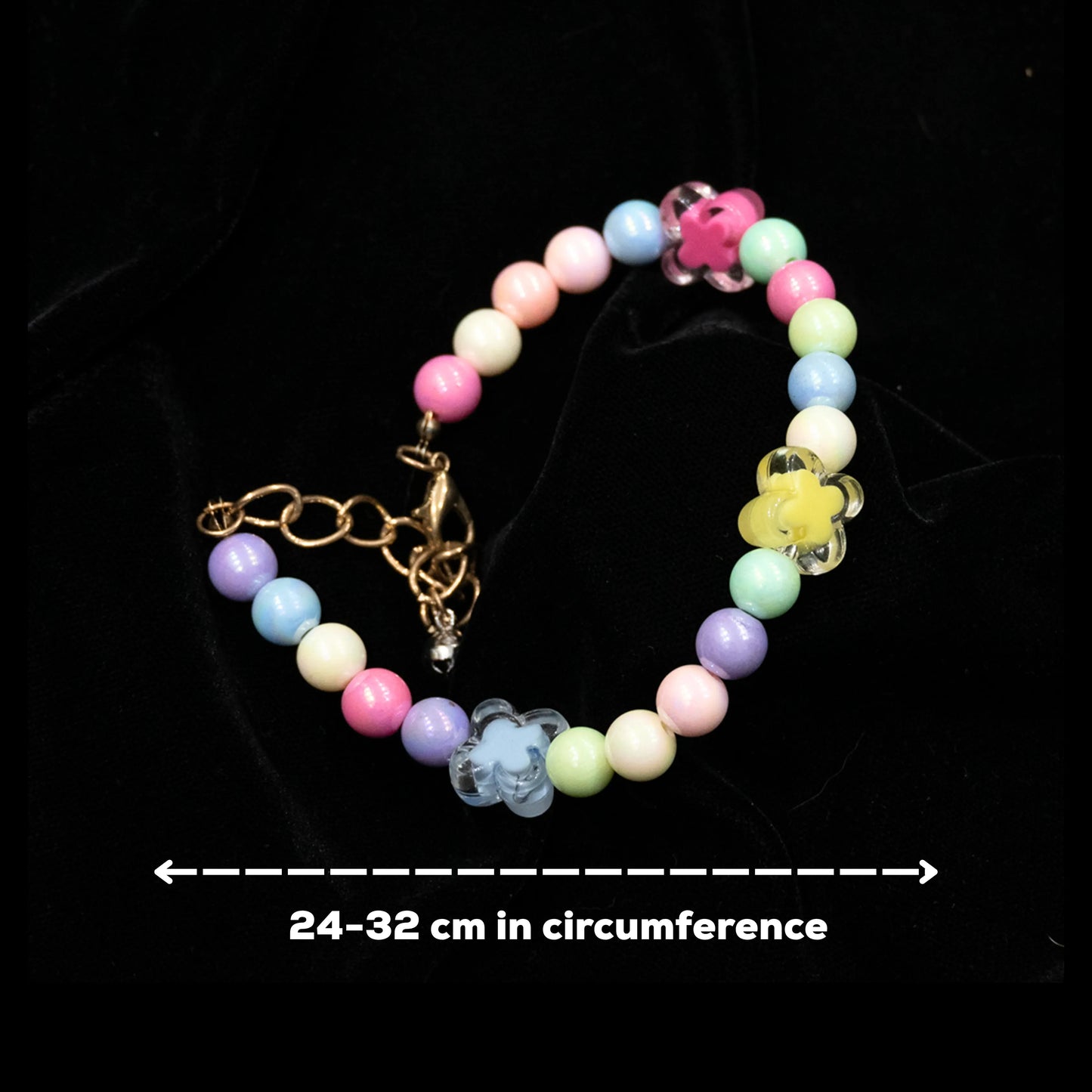 Multi-color beaded pet necklace laid out flat on a black background