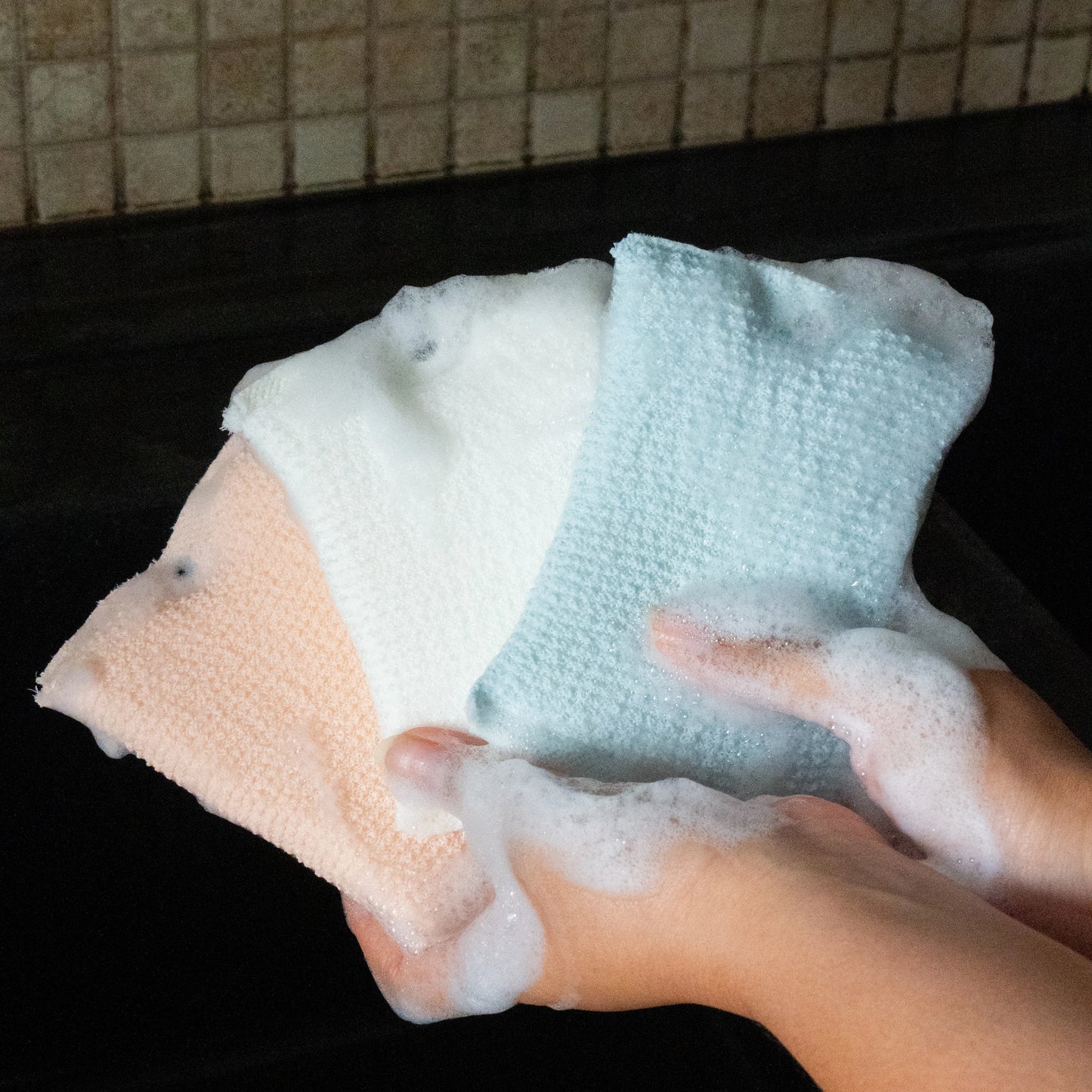 Hand holding all the three wipes