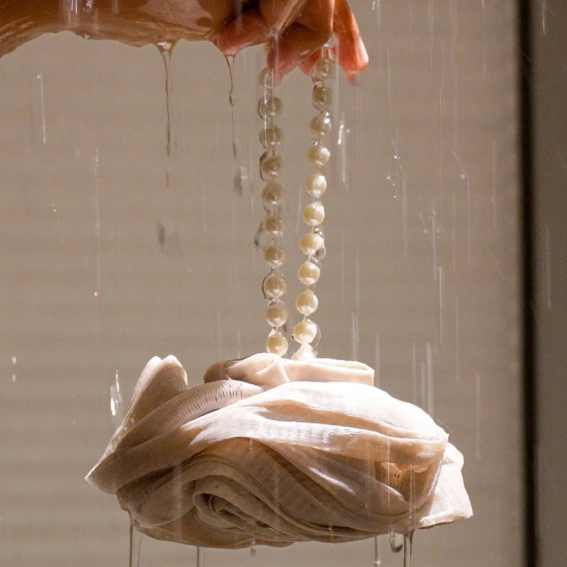 Foam Ease loofah body cleaner displayed flat with attached hanging loop
