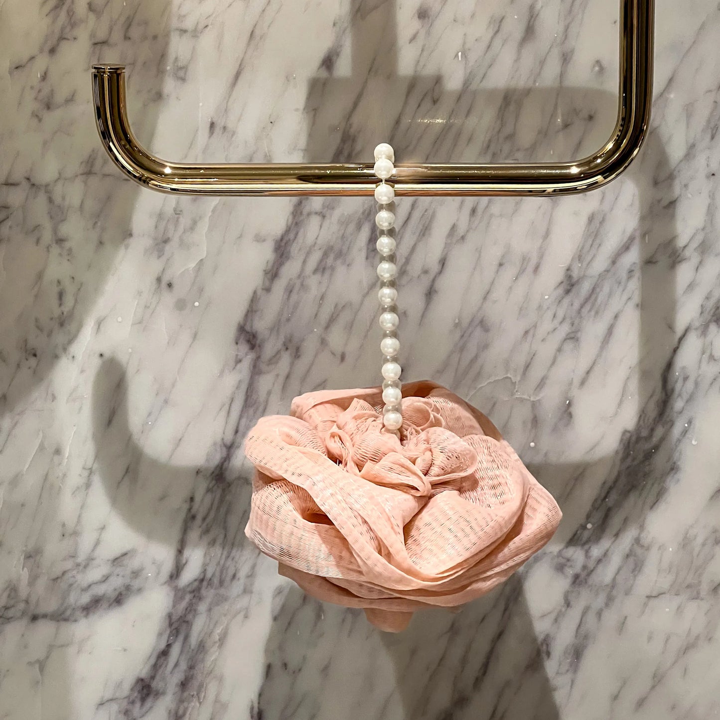 Foam Ease loofah body cleaner displayed flat with attached hanging loop