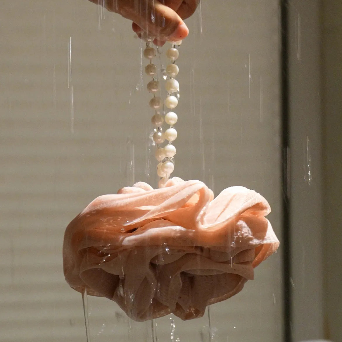 Foam Ease loofah body cleaner displayed flat with attached hanging loop