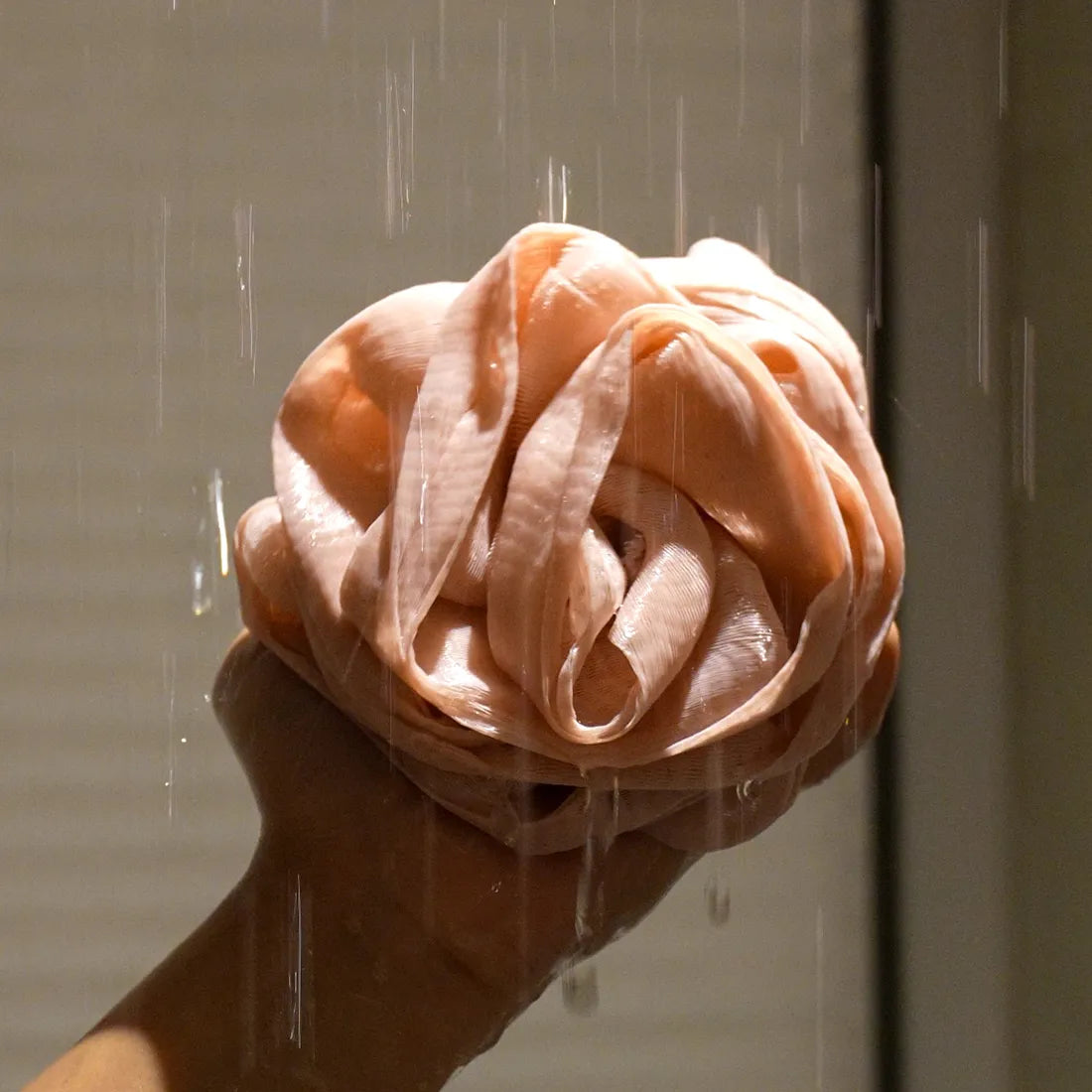 Side angle of the Foam Ease Plush Loofah highlighting its plush and fluffy design