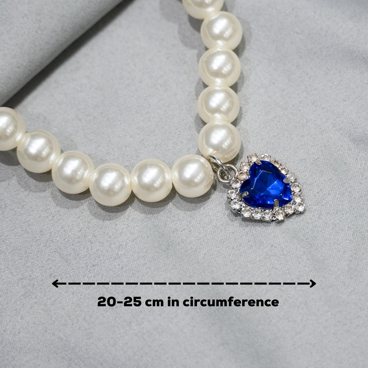 Close-up of deep blue gemstone charm on grey background