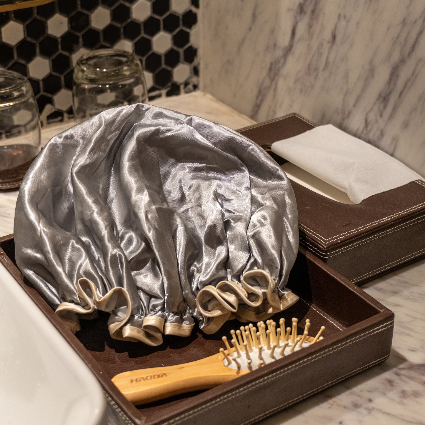 Grey shower cap placed on counter.