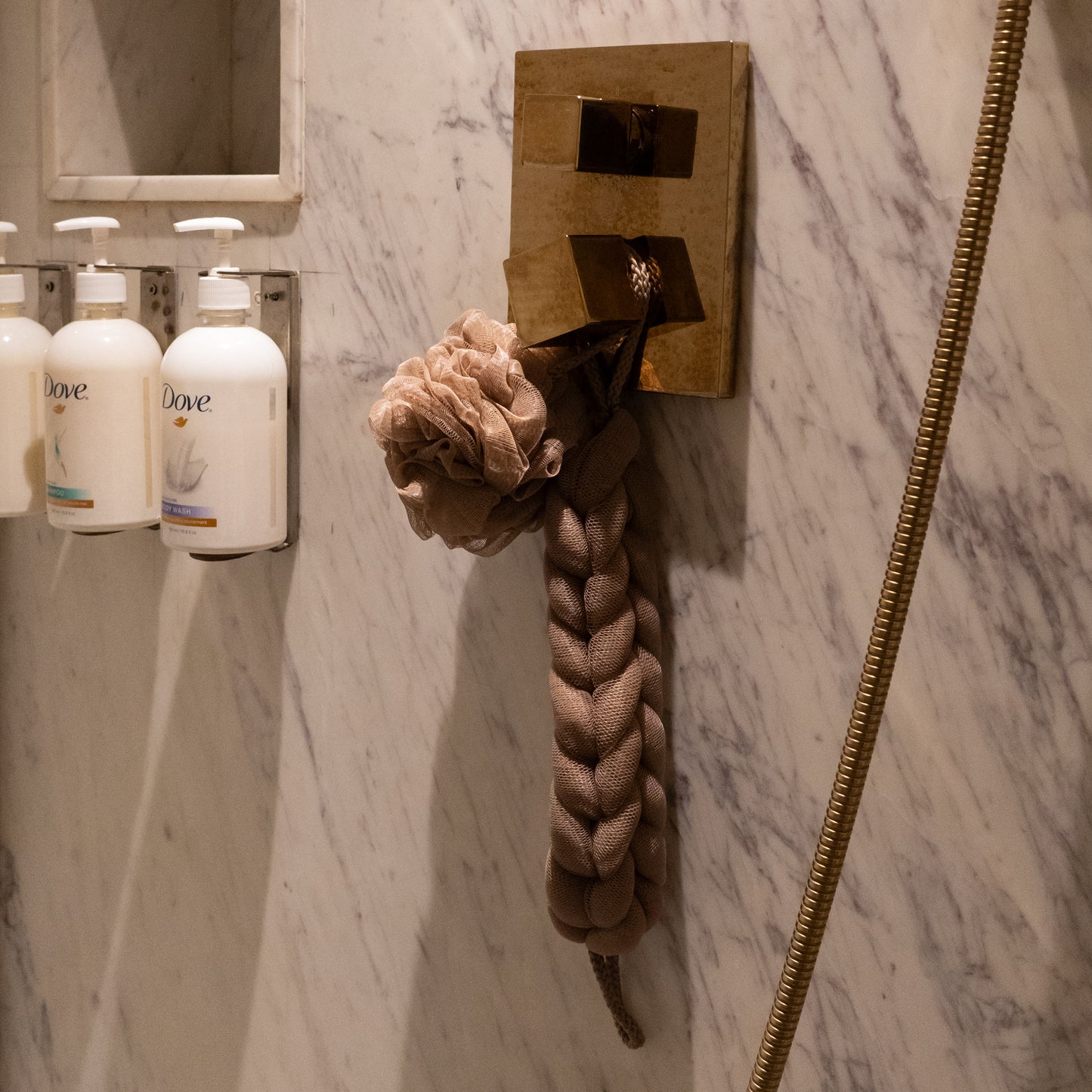 Detailed view of brown braided scrubber, soft hair towel, and exfoliating loofah