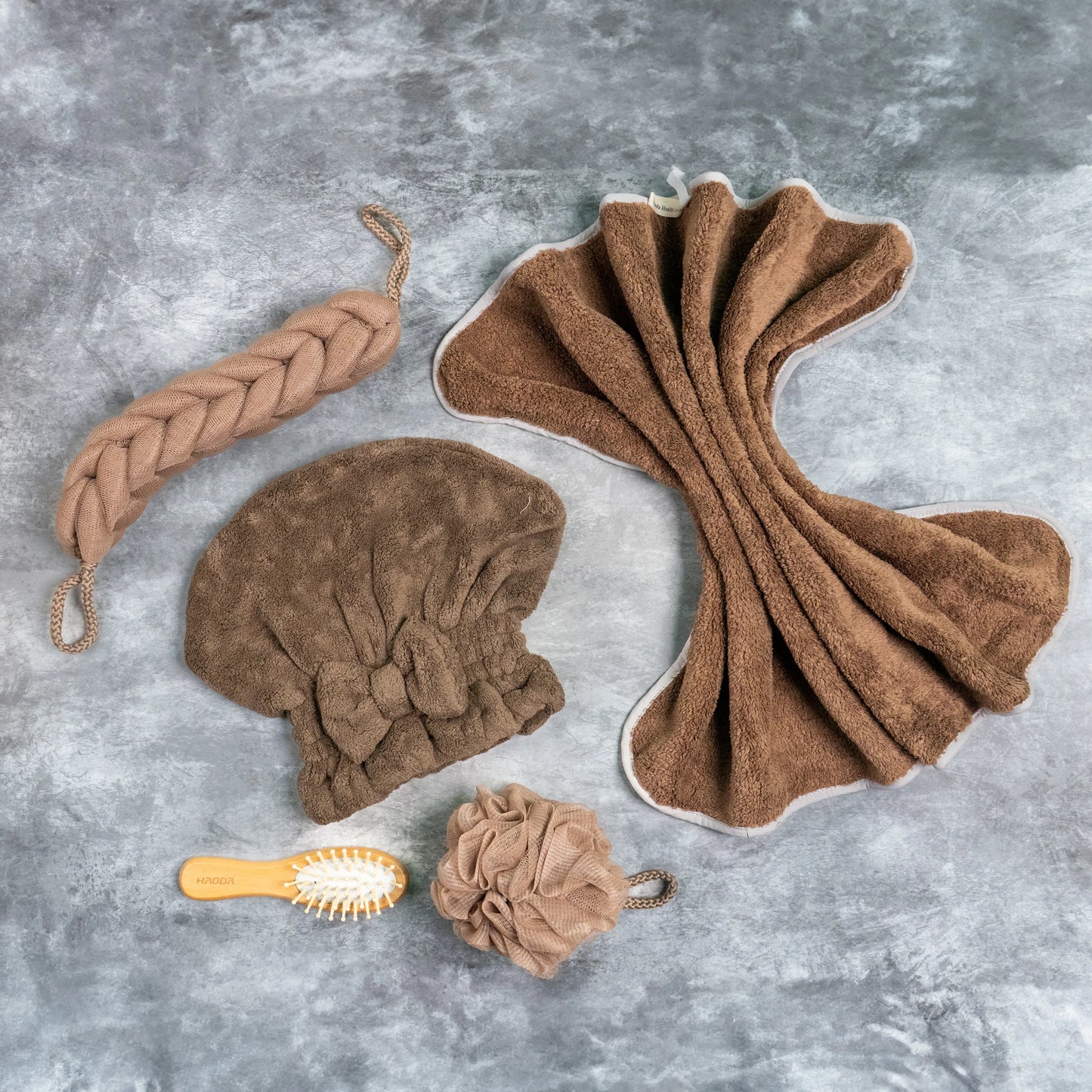 Brown bath combo kit showcasing all accessories on grey marble surface