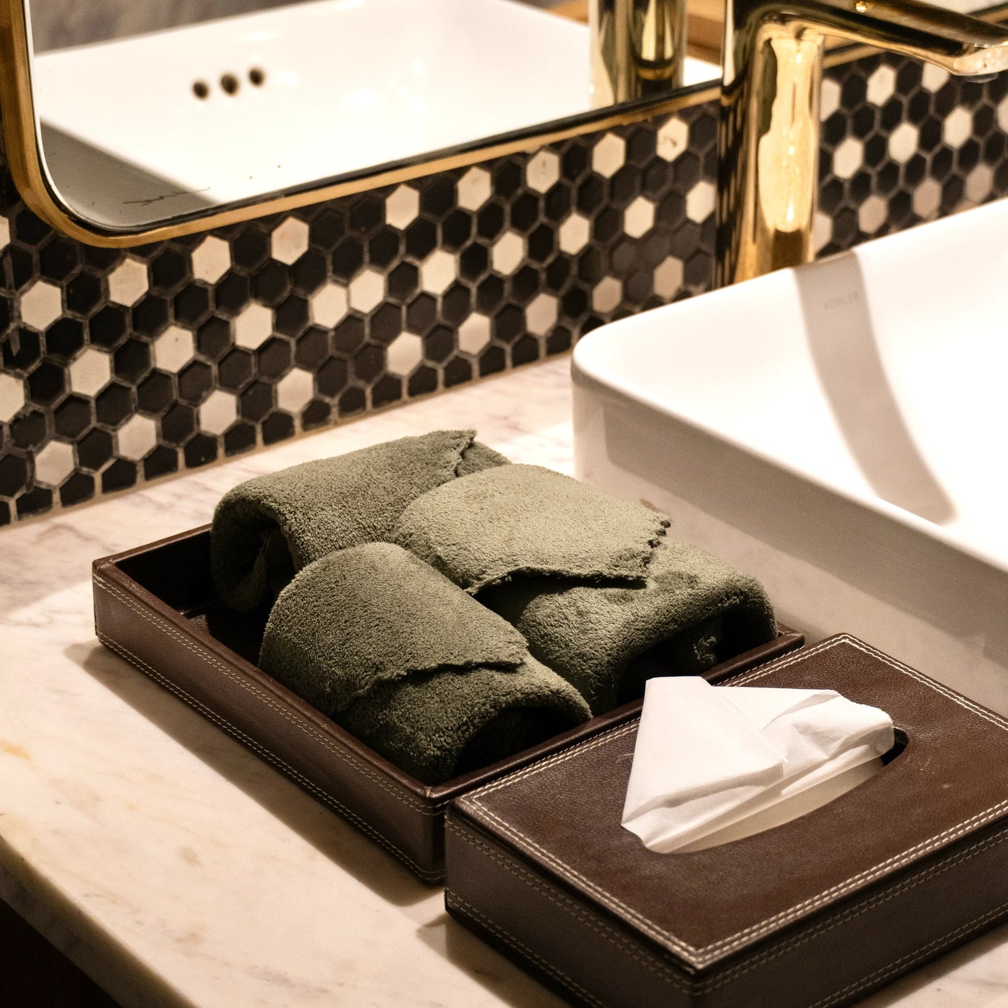 Olive green towel displayed in the bathroom