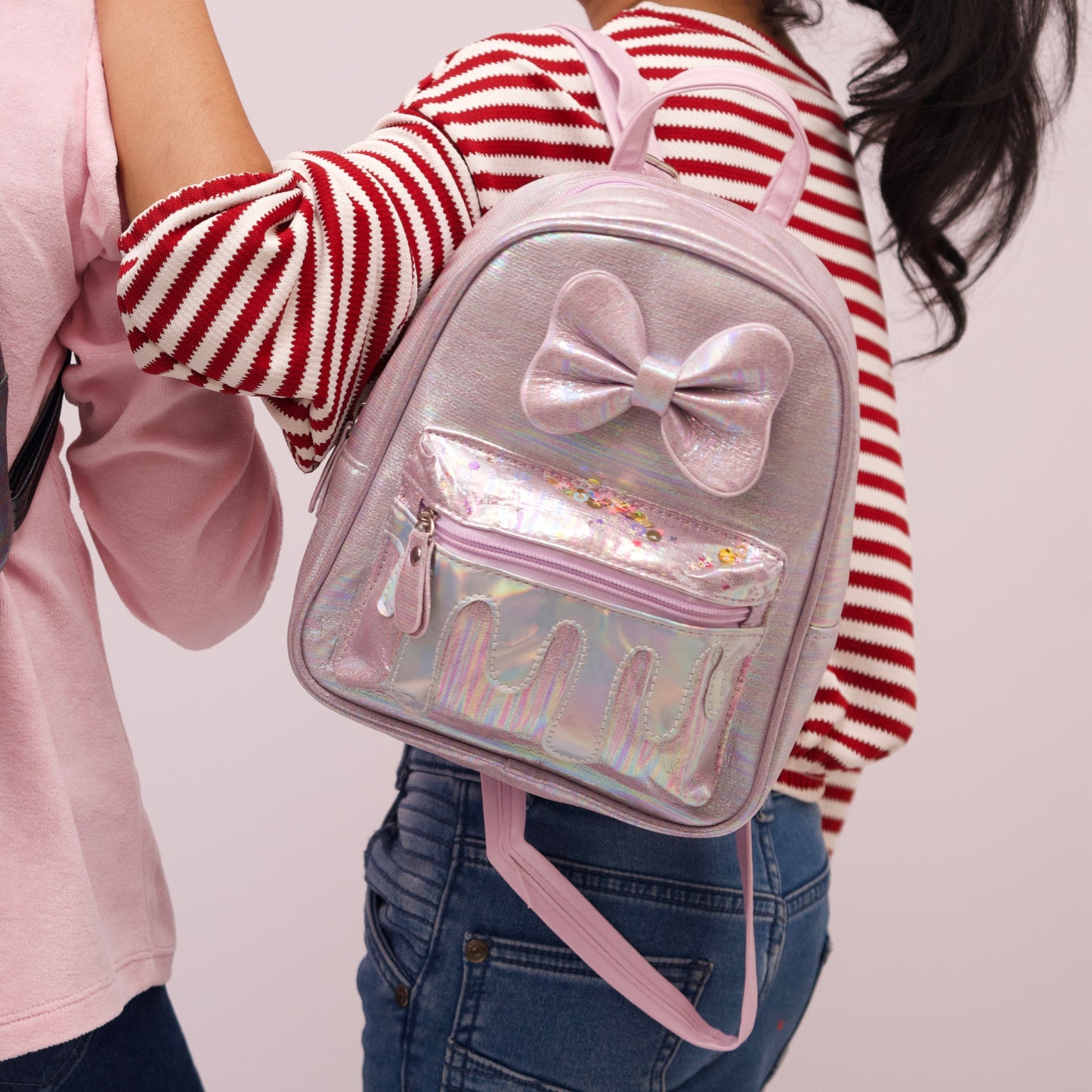 Stylish black school bag for kids featuring a glittery bow and drip effect