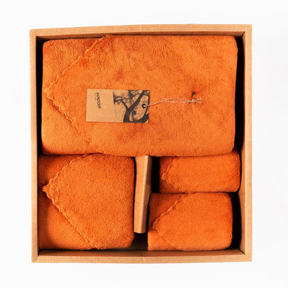 Soft Craze 4-Piece Size-Varied Towel Set in vibrant orange displayed in stacked arrangement