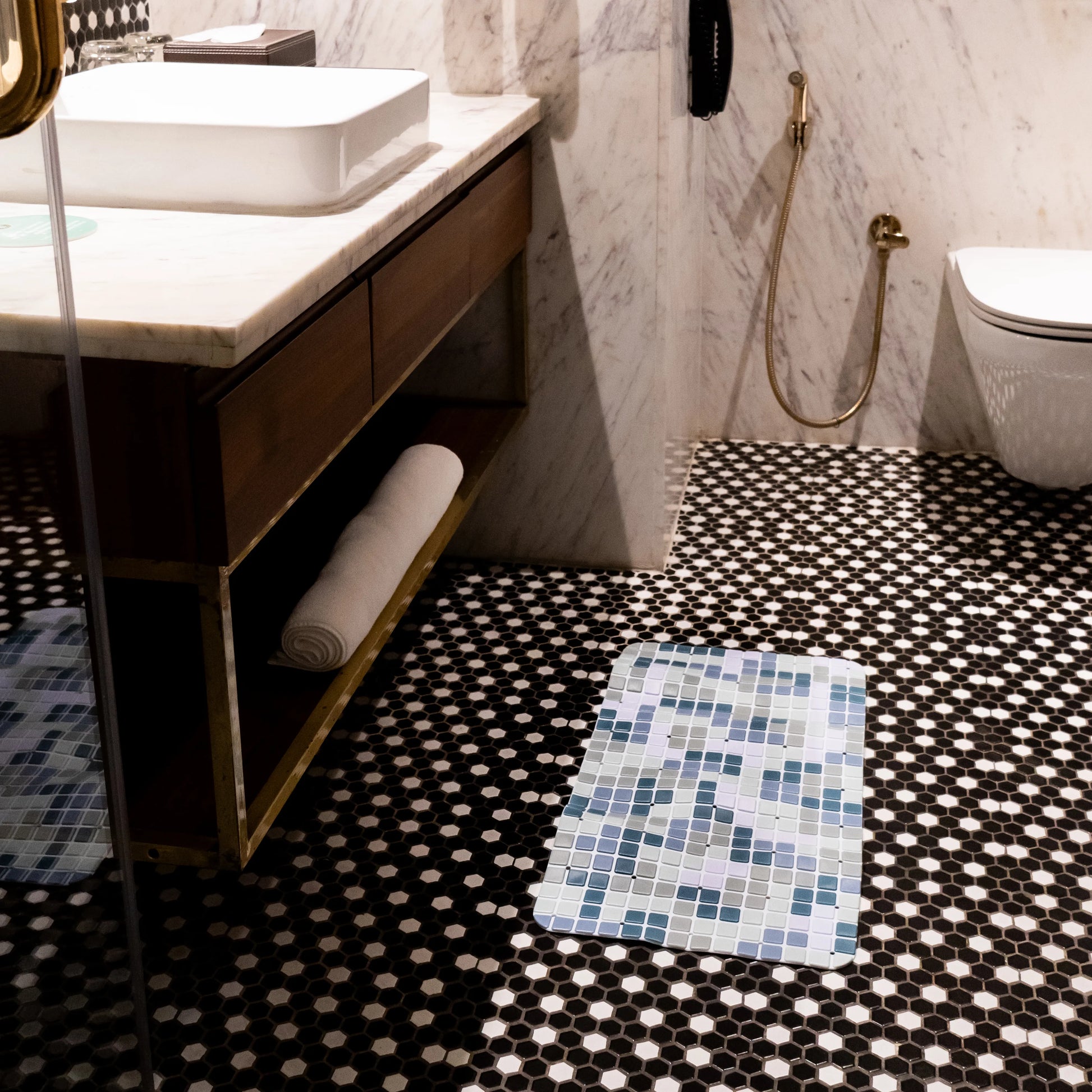 Blue-green mat placed below bathroom sink.
