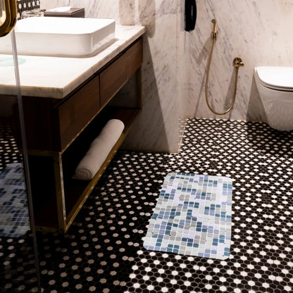 Blue-green mat placed below bathroom sink.
