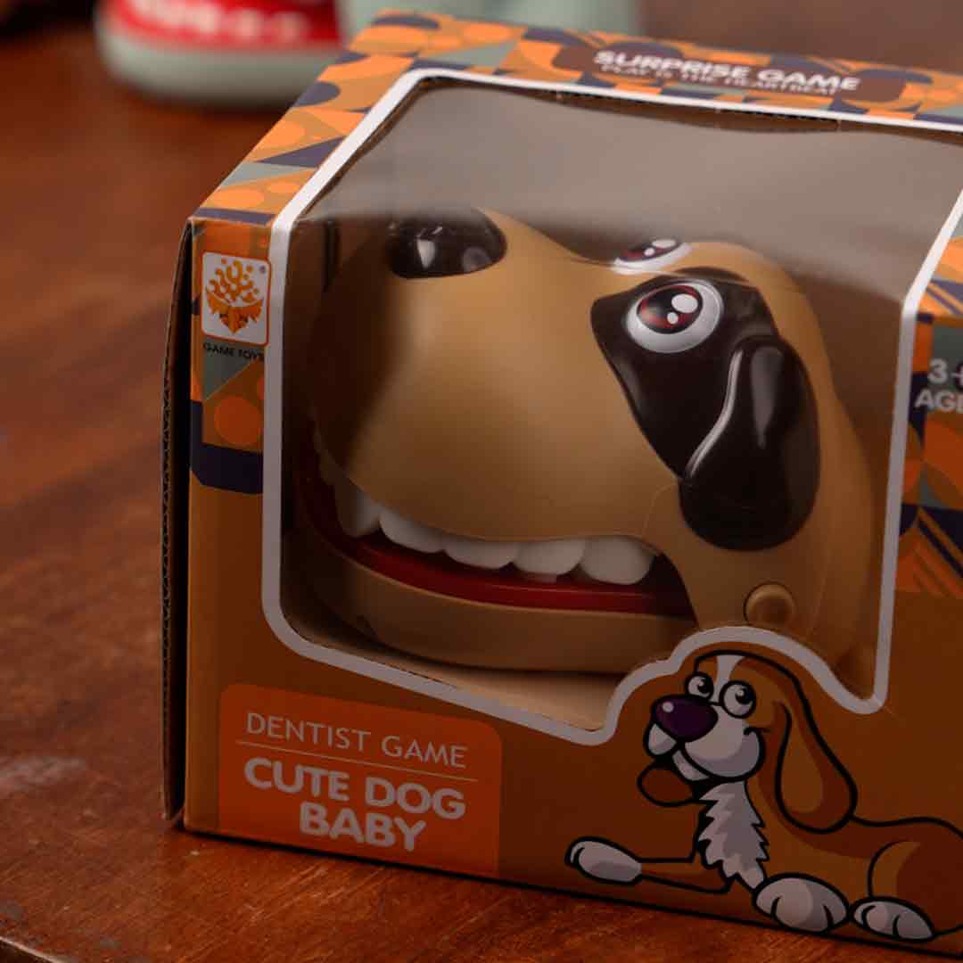 Close-up on the durable plastic teeth mechanism of the Bite the Button Game boxed view