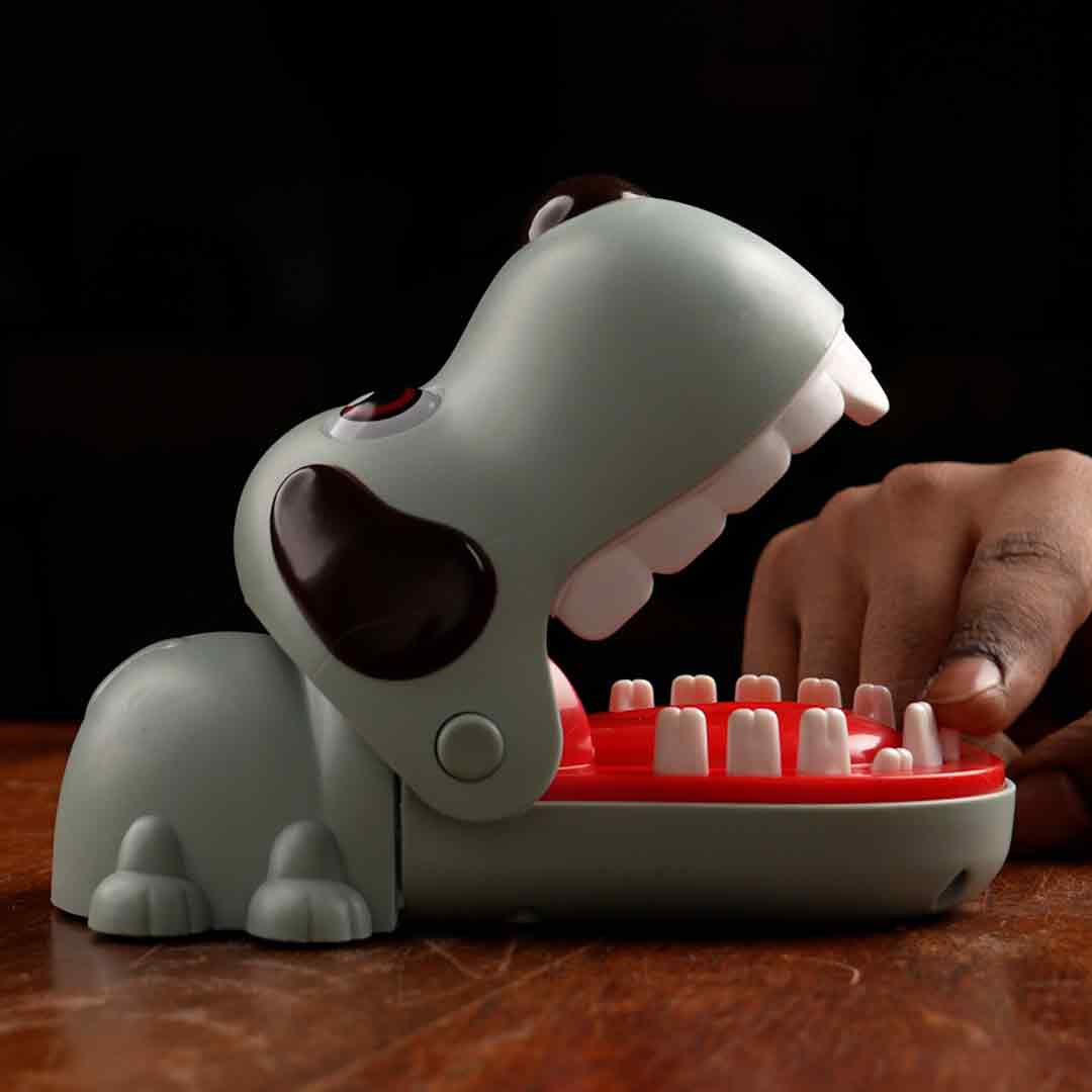 Close-up of a player’s finger pressing a tooth on the Bite the Button Game