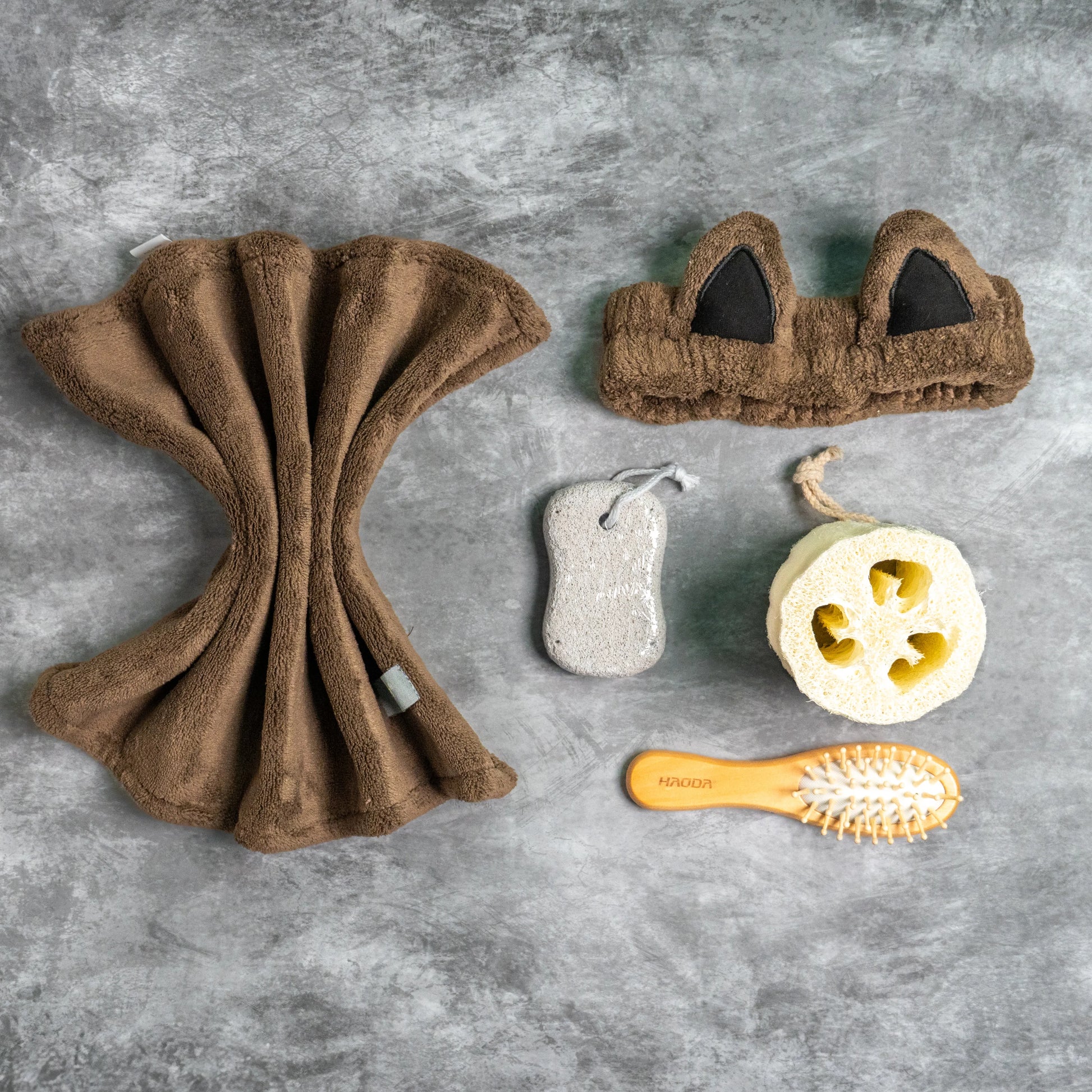 Brown combo set arranged with pumice stone and loofah for spa use.