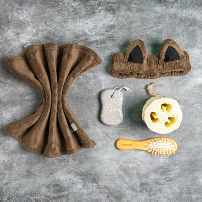 Brown combo set arranged with pumice stone and loofah for spa use.