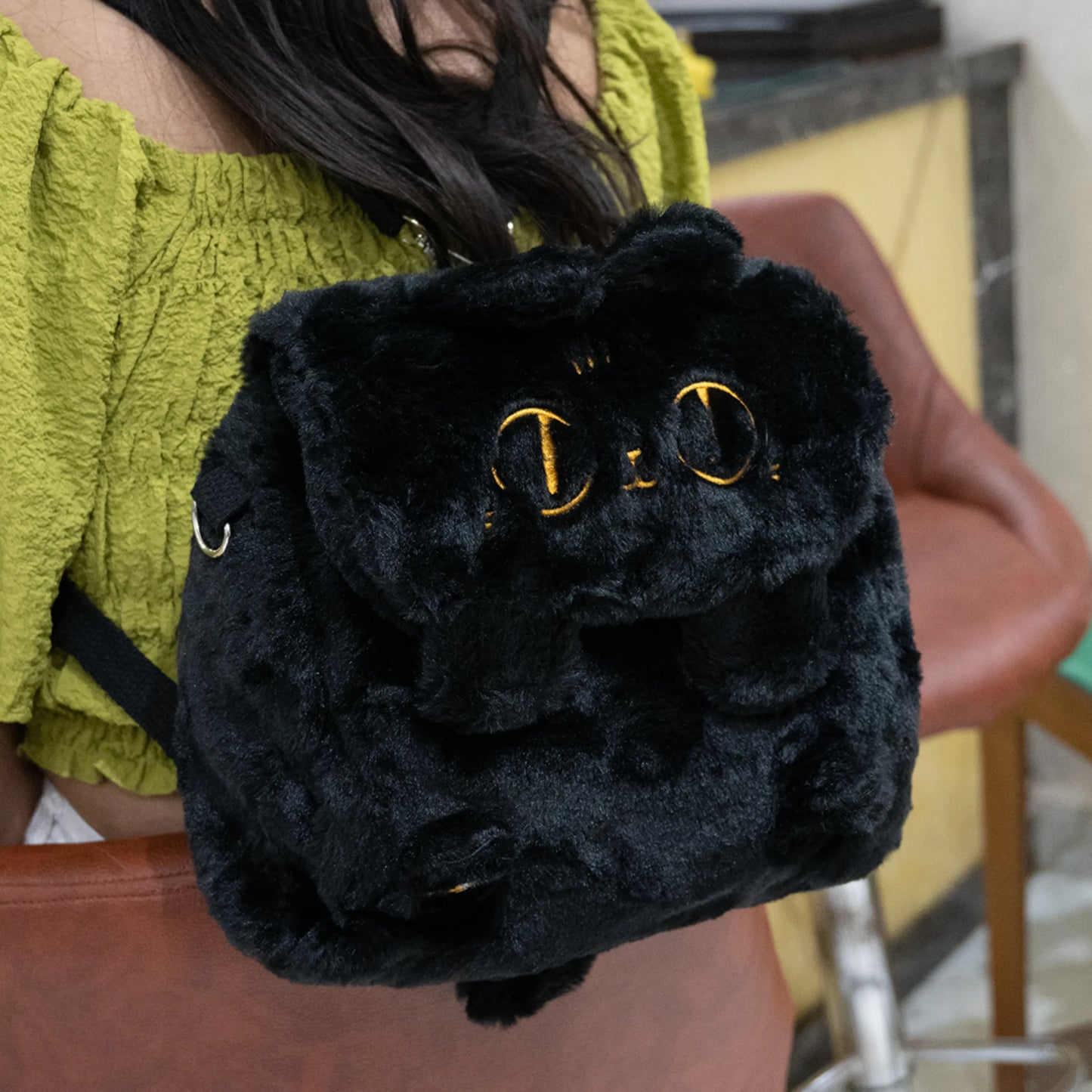 Fluffy black convertible backpack on a women