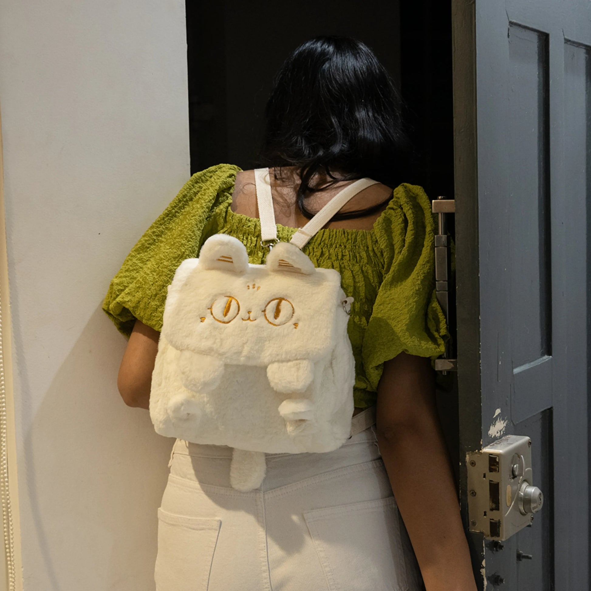 Fluffy white convertible backpack on a women