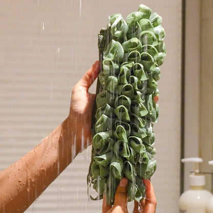 Glow loop held by a person with water falling on it in the shower.