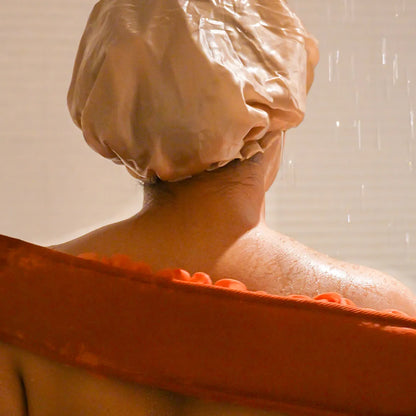 Woman using the orange glow loop on her back.