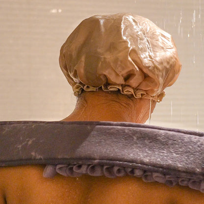 Woman using the purple glow loop on her back.
