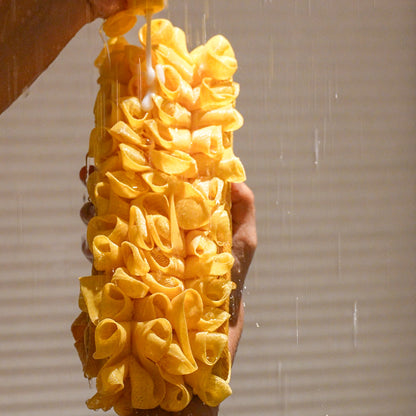 Glow loop held by a person with water falling on it in the shower