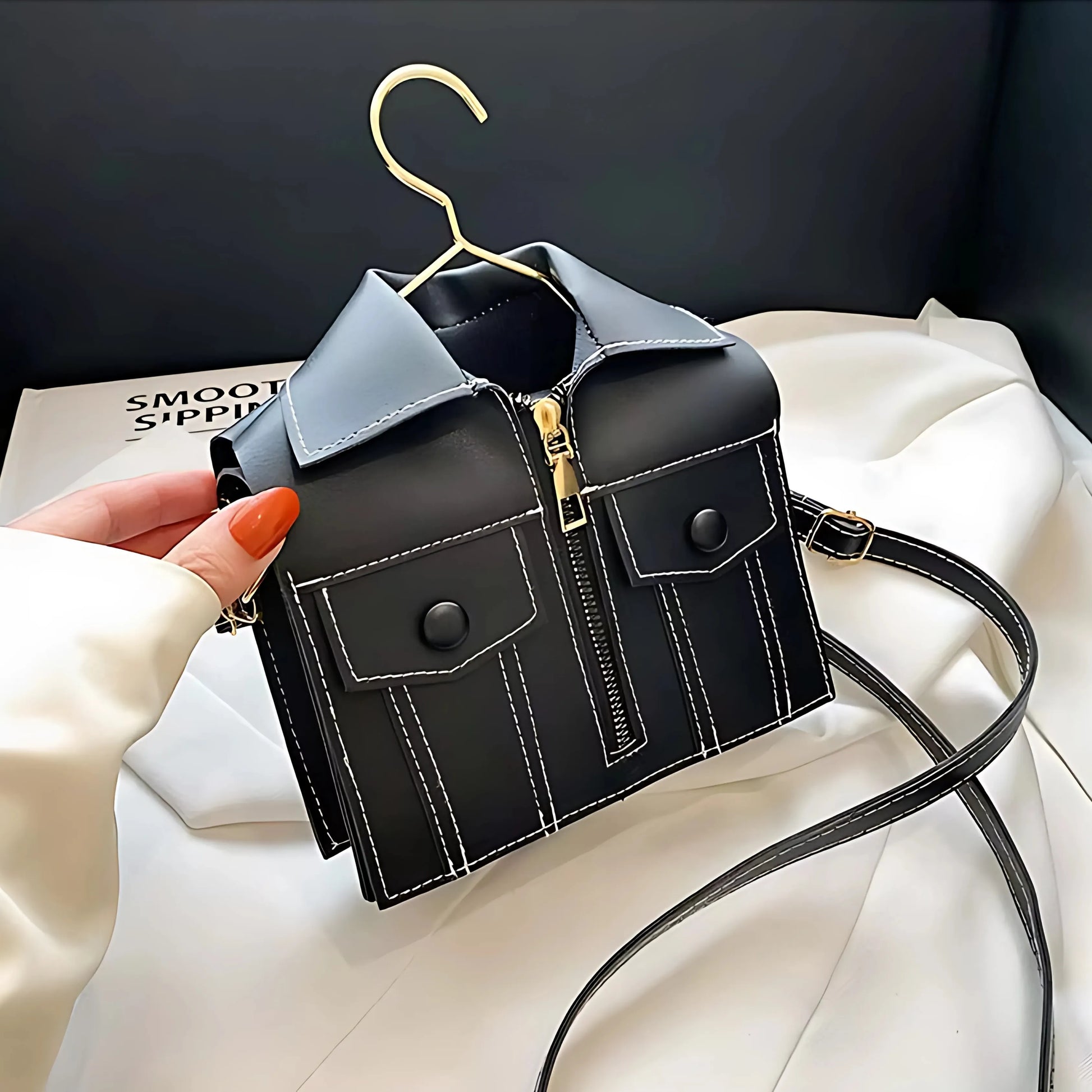 Side view of black Luxury Jacket Style Handbag with tailored pocket details