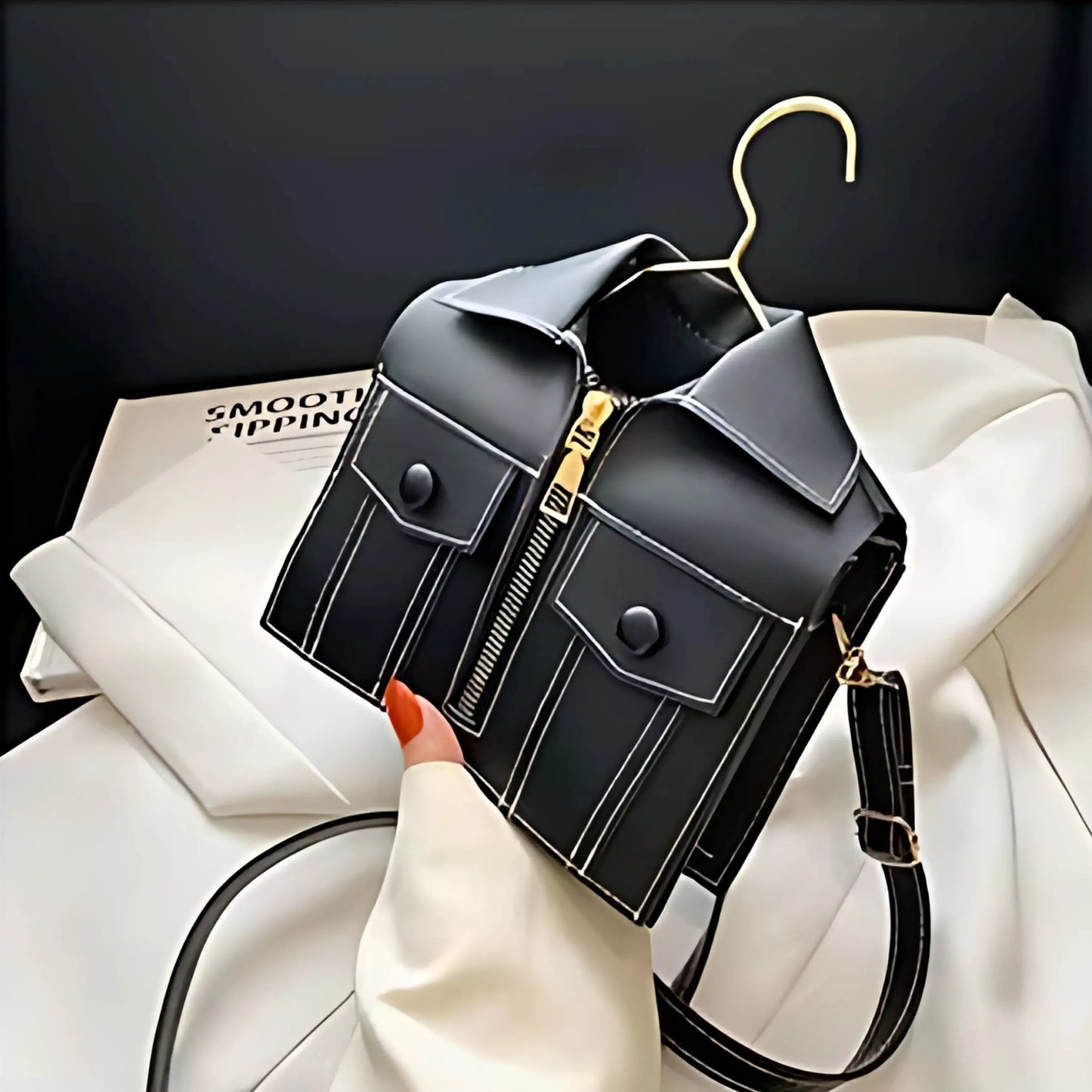 Tilted view of black Luxury Jacket Style Handbag with tailored pocket details