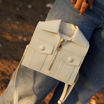 Woman holding the brown jacket-inspired handbag on outdoors setup