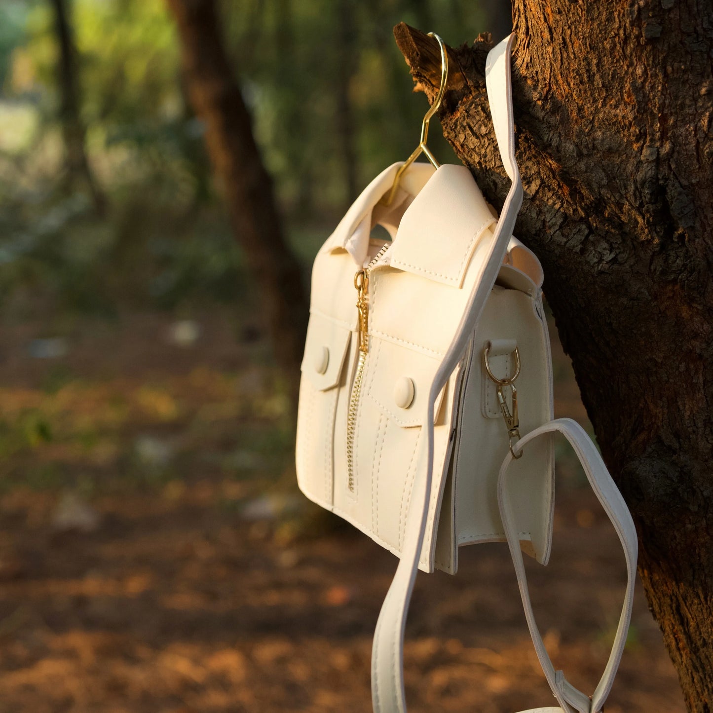 Tree holding the white jacket-inspired handbag
