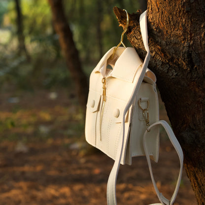 Tree holding the white jacket-inspired handbag