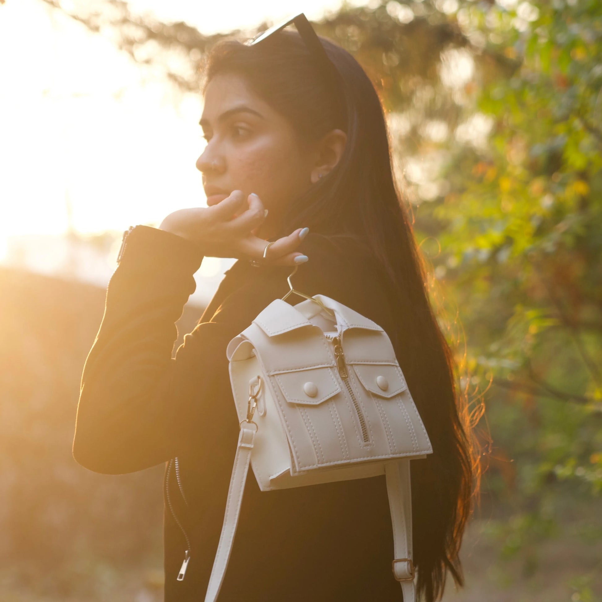 Woman holding the white jacket-inspired handbag