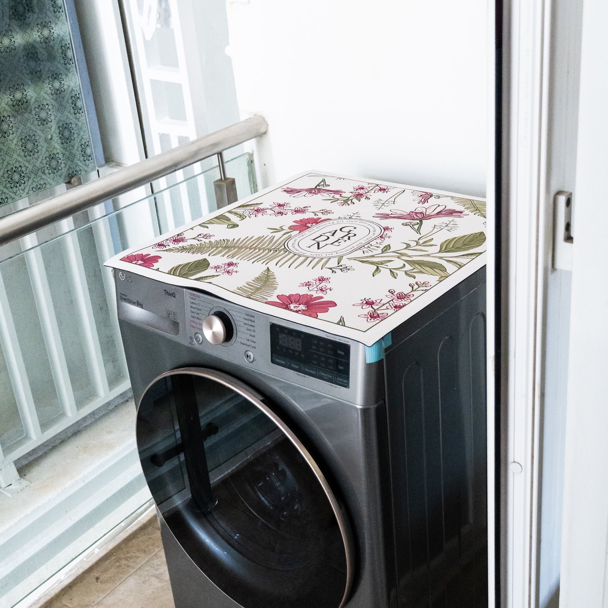 Pink mat placed on top of washing machine.