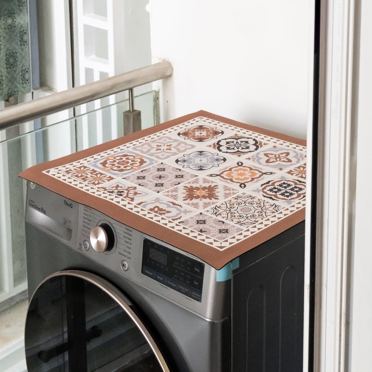 Beige mat placed on top of washing machine.