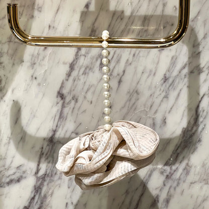 Foam Ease loofah body cleaner displayed flat with attached hanging loop