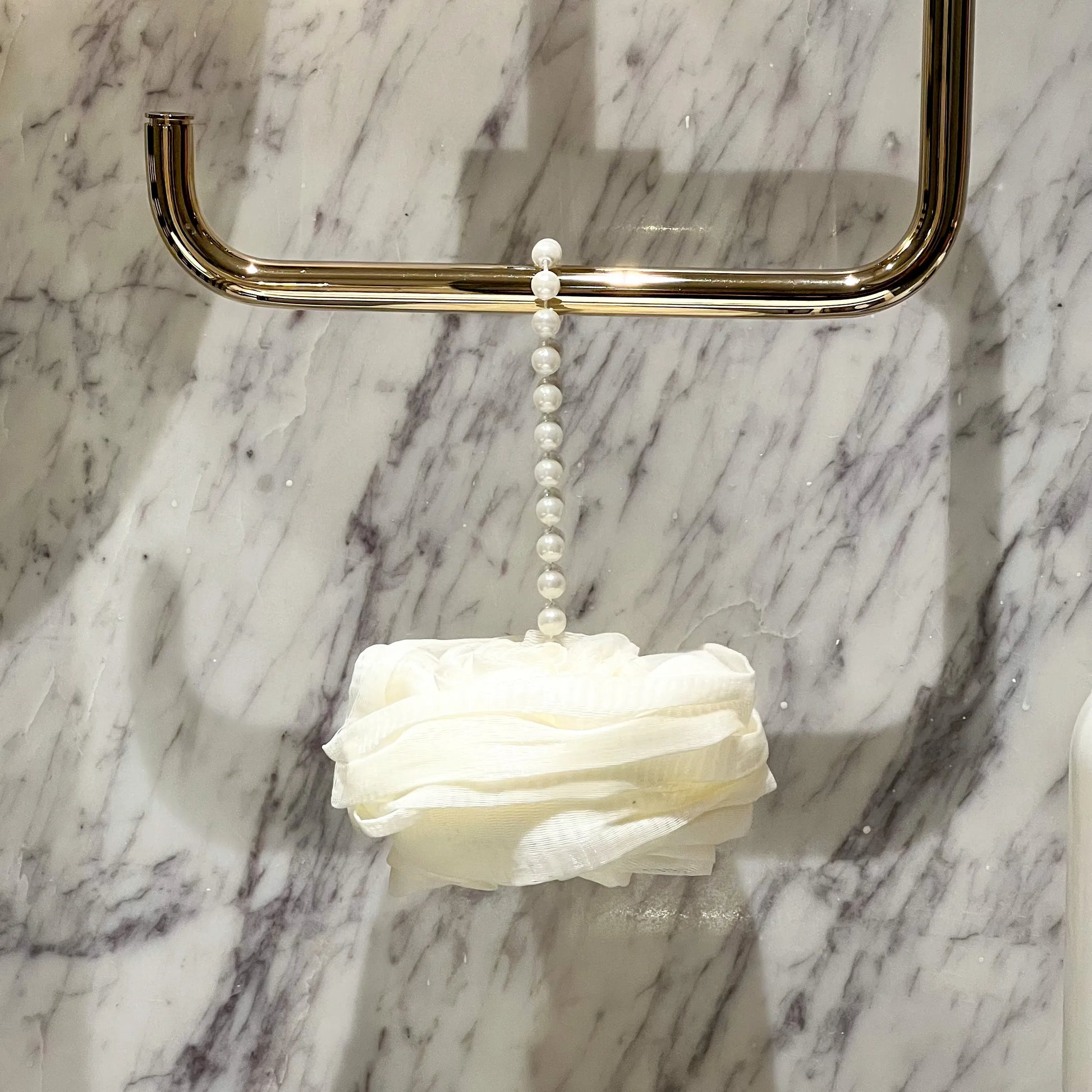 Foam Ease loofah body cleaner displayed flat with attached hanging loop