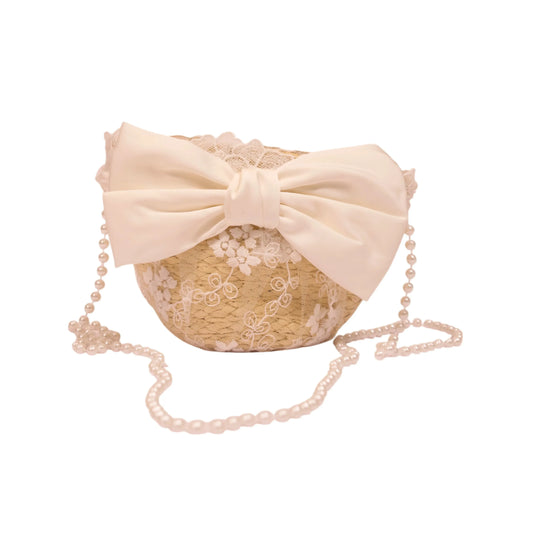Elegant beige lace handbag with a large ivory satin bow, floral embroidery, and a pearl-beaded shoulder strap.