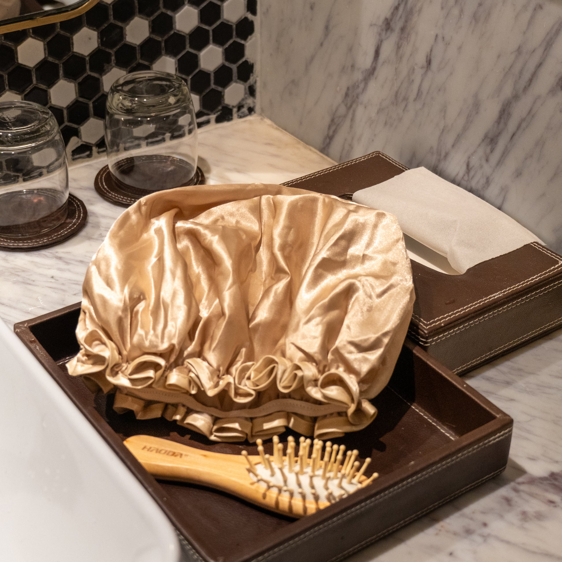 Beige shower cap placed on counter.