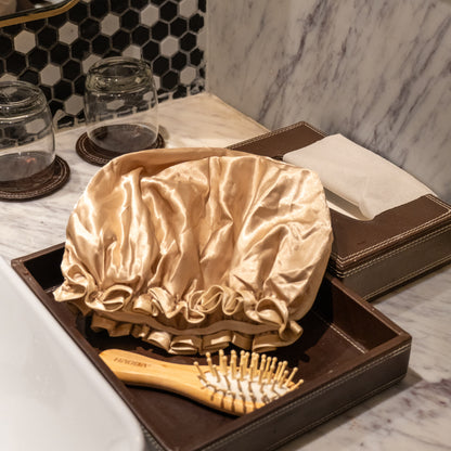 Beige shower cap placed on counter.