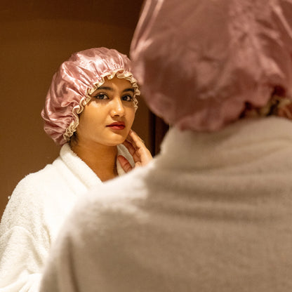 Woman wearing pink shower cap.