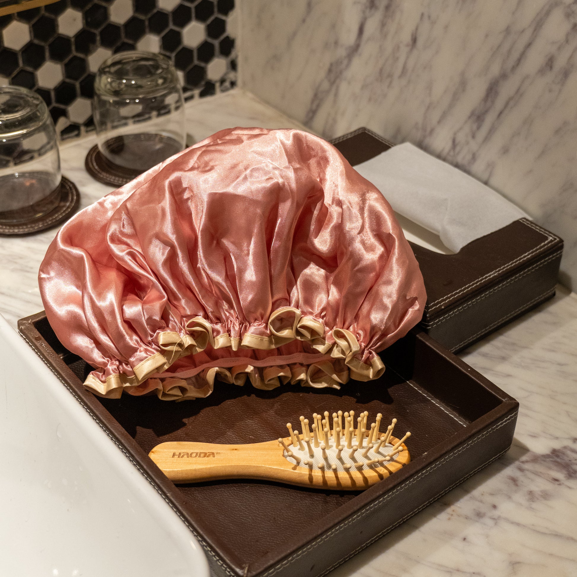 Pink shower cap placed on counter.