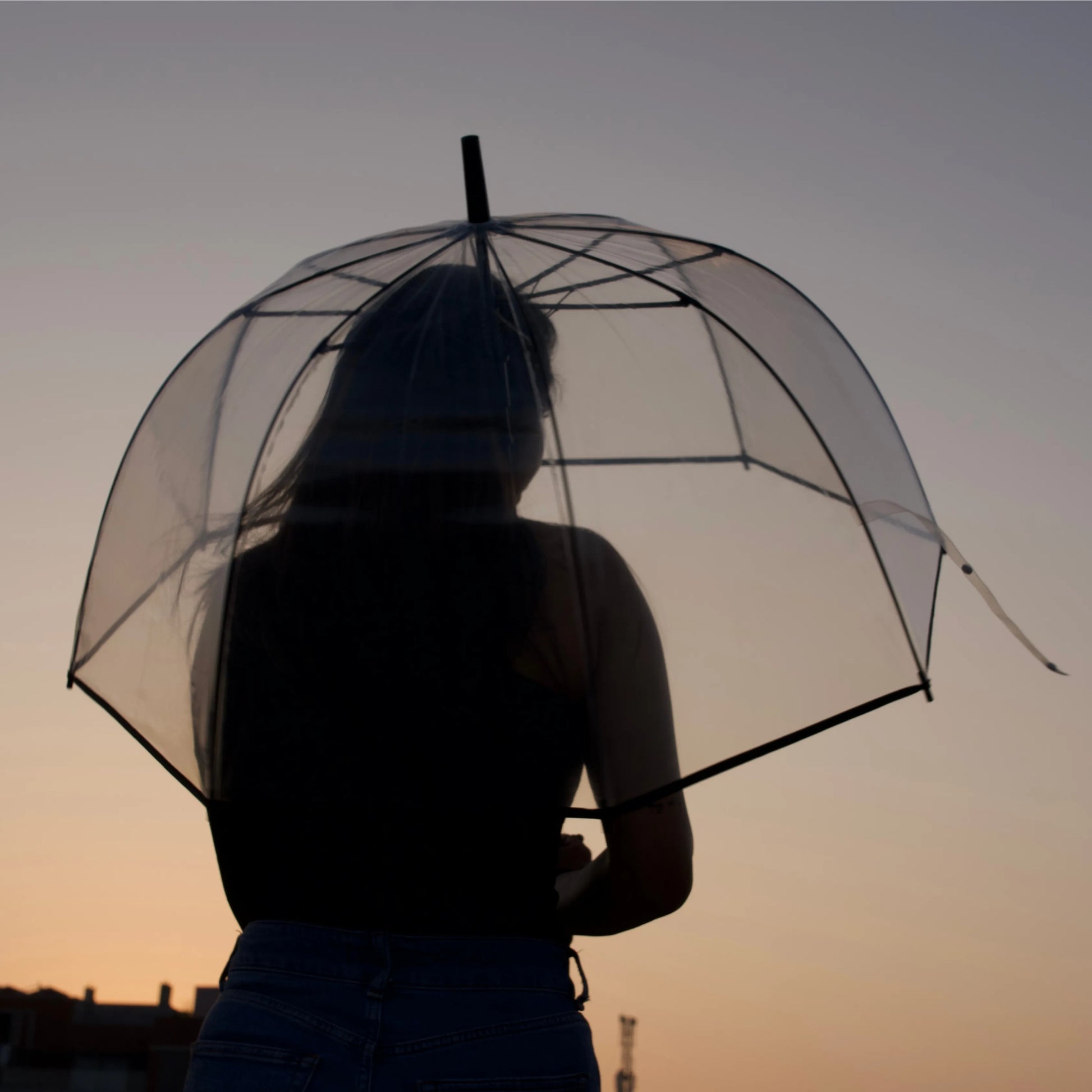 Woman walking with transparent hook umbrella